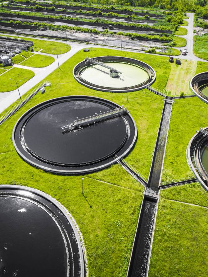 Sewage farm. Static aerial photo looking down onto the clarifyin Sewage farm. Static aerial photo looking down onto the clarifying tanks and green grass. Geometric background texture.